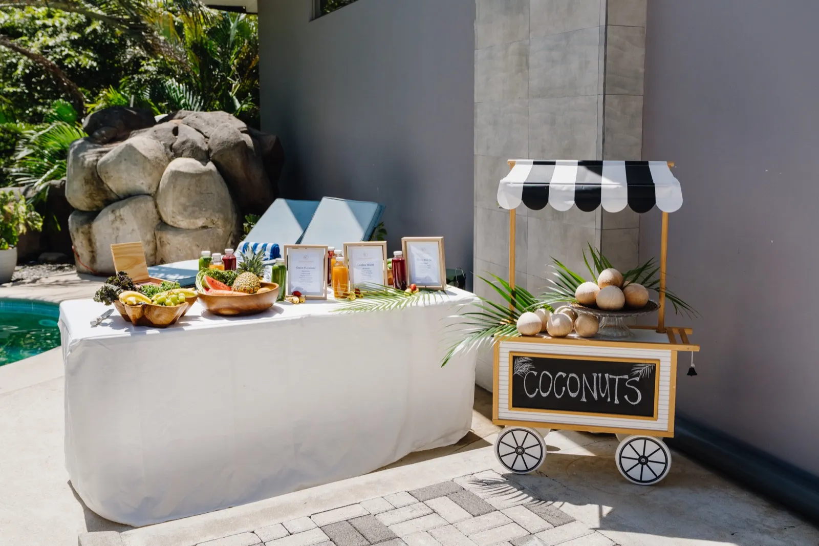 Fresh coconuts and cold-pressed juices set up poolside
