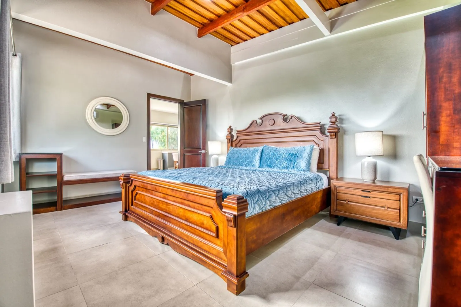 Seascape villa colonial bedroom with blue quilted bed