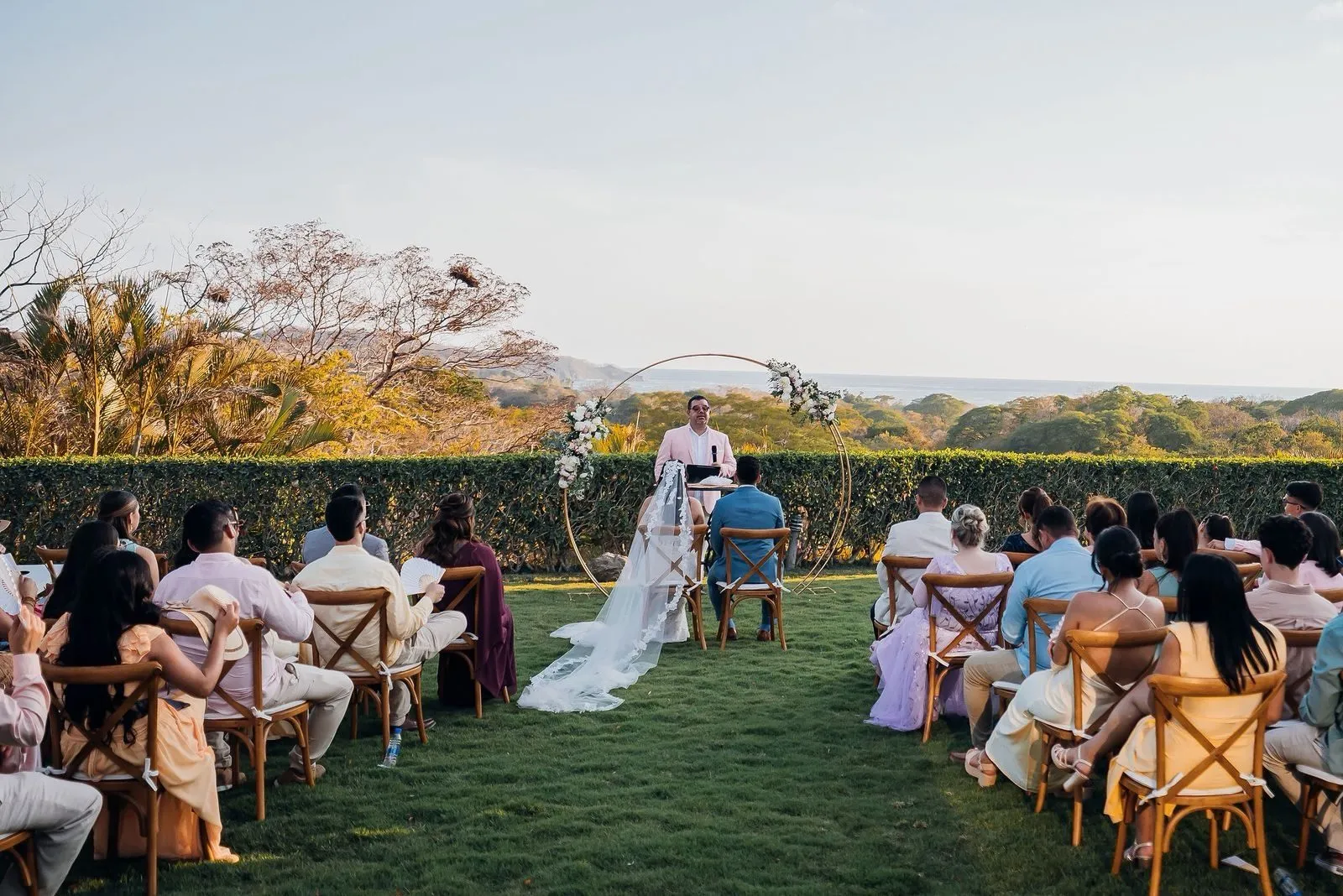 Ceremony at the circular floral arch overlooking the Nosara valley
